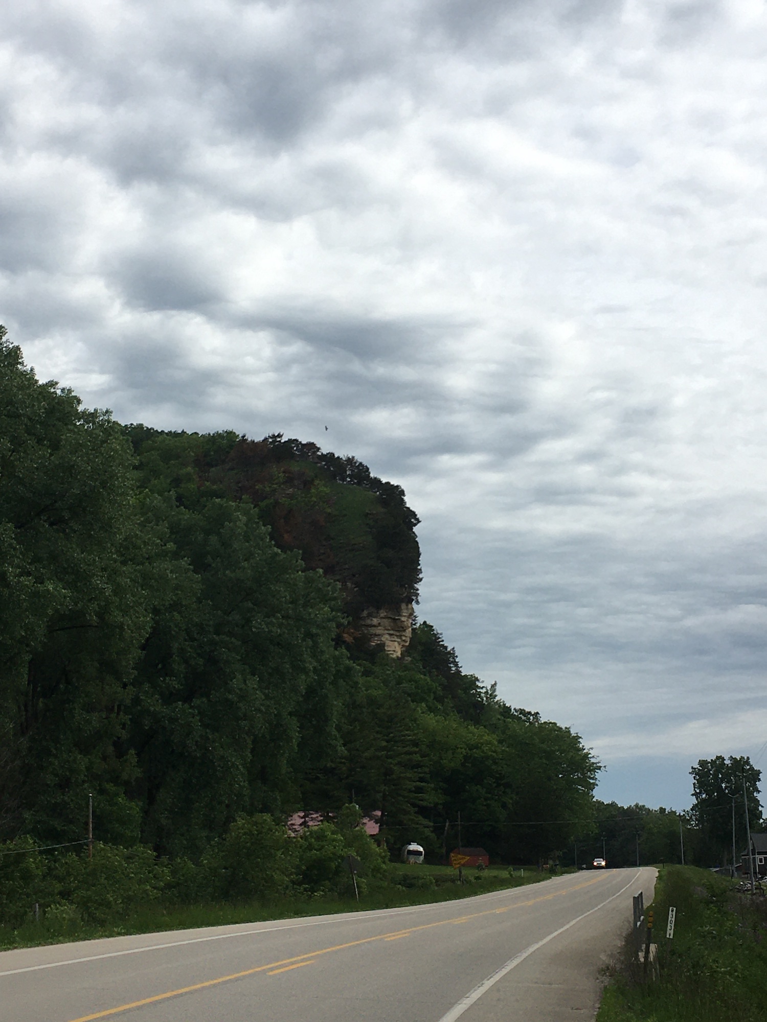 Bluff overlooks the road with lovely textured clouds overhead