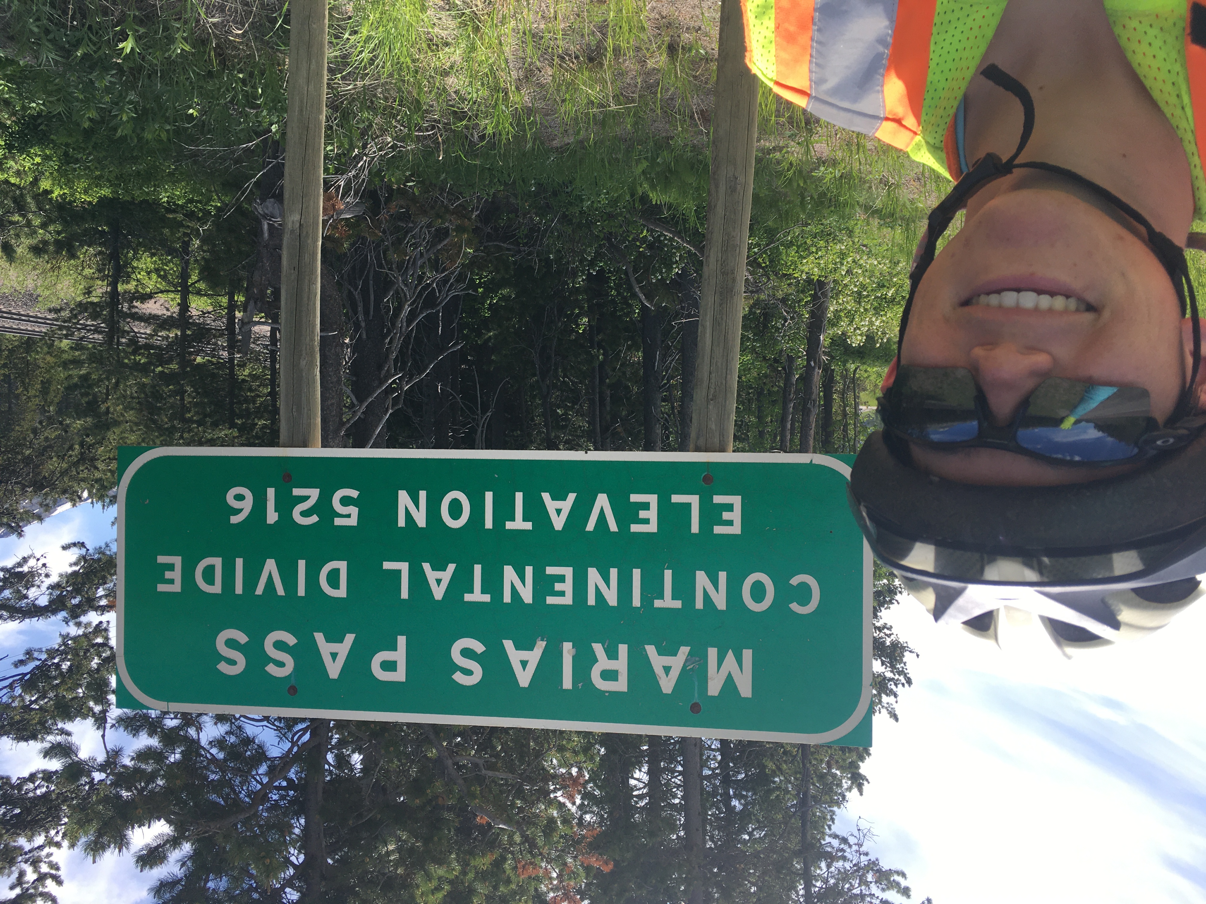 Zeph, wearing helmet and
reflective vest, takes a selfie in front of a sign reading MARIAS PASS
CONTINENTAL DIVIDE ELEVATION 5216