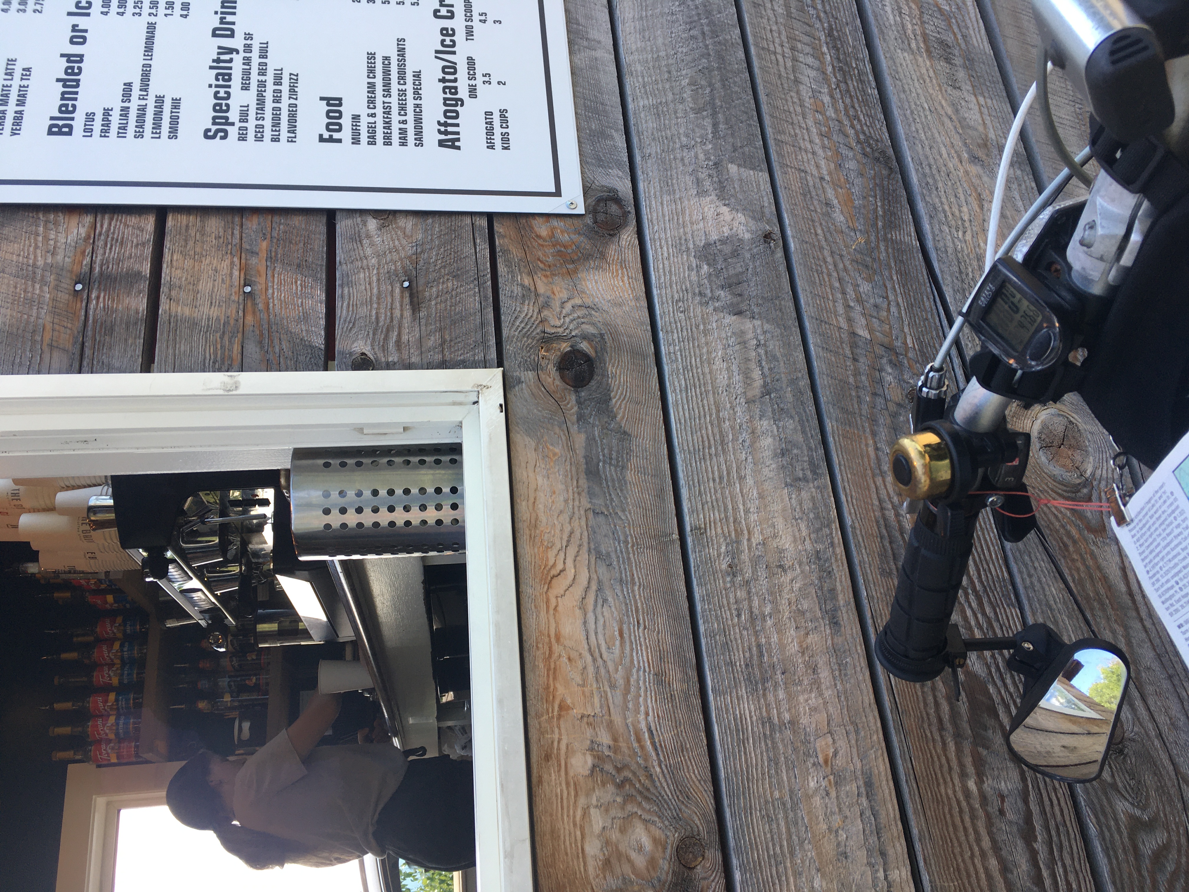 a drive-through window with
part of a menu visible and Zeph's handlebars in the foreground