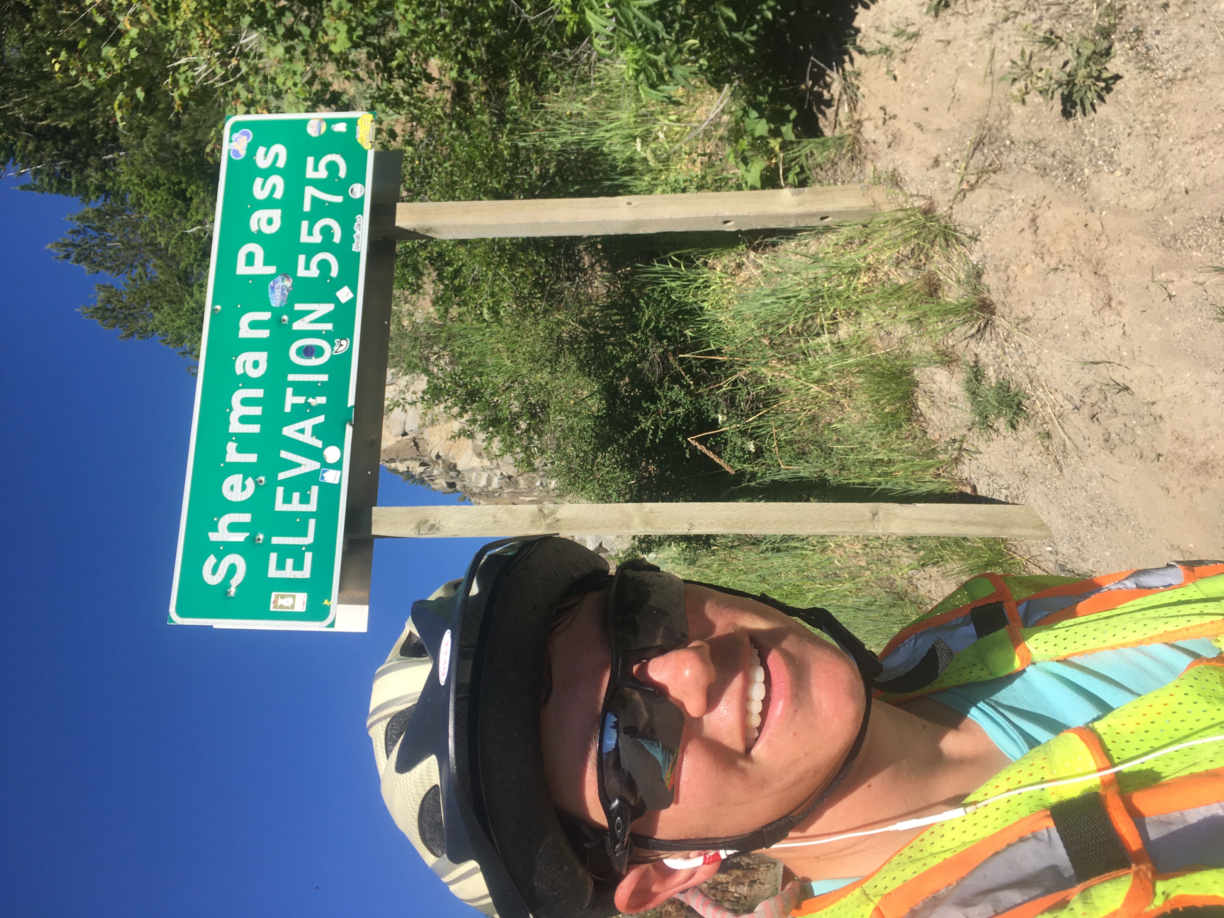 Zeph poses in front of a sign
reading Sherman Pass ELEVATION 5575